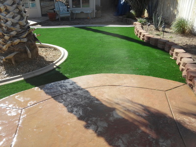 Stamped concrete with artificial grass installation