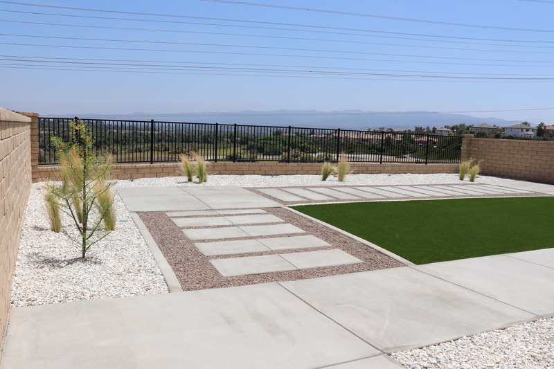 This combination of artificial grass and low maintenance landscaping adds to the view of Santa Clarita.