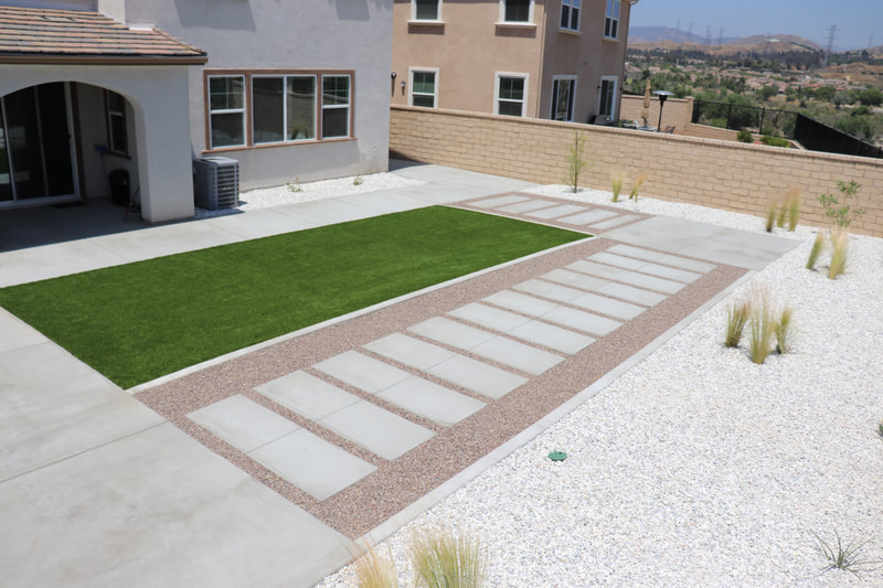 This new Santa Clarita home has artificial grass landscaping to reduce maintenance.