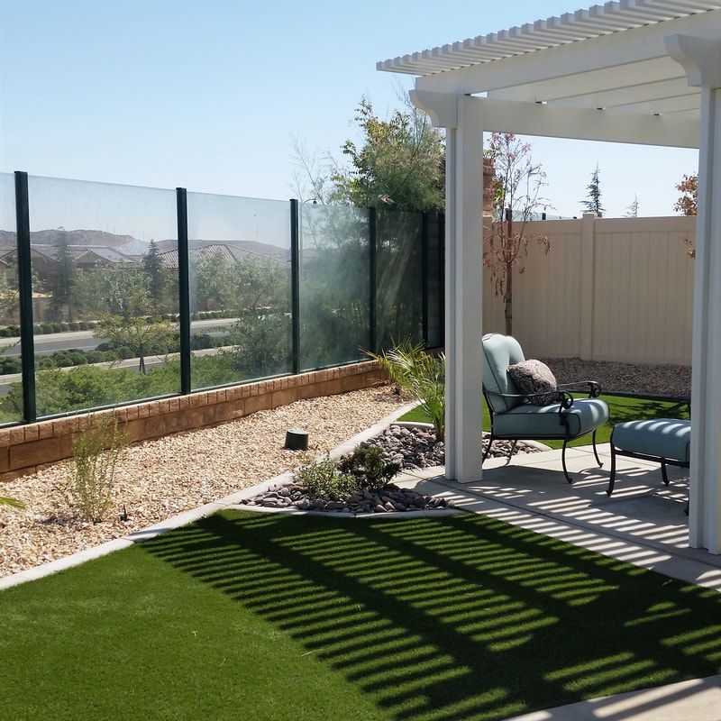 Outdoor living space with pergola and artificial turf